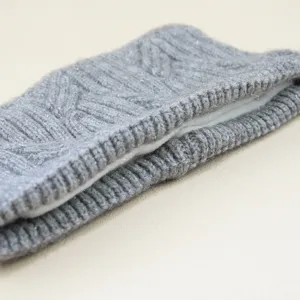 Grey knitted cable headband detail, plush fleece lined winter ear warmer accessory.