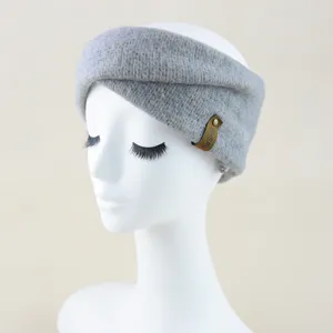 Soft grey mohair knit cross headband for winter warmth, stylish wide hair band detail.