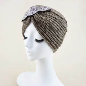 Detailed view of the brown rhinestone leaf knit turban hat as a warm winter accessory.