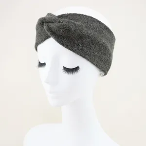 Detailed view of dark grey knitted twist headband, elastic wide hair band for daily wear.