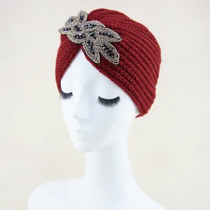 Vista detallada del gorro turbante tejido rojo con cuentas de cristal negro de lujo.