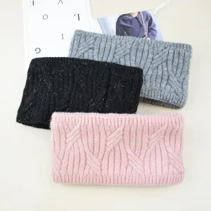 Close-up detail shot of thick knitted winter fleece-lined headbands in three stylish colors.