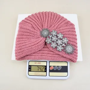 Detailed view of the pink rhinestone knitted turban hat, warm winter ethnic pullover cap for women.