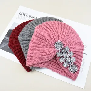 Detail view of stylish rhinestone embellished knitted turban hat, warm winter beanie for women.