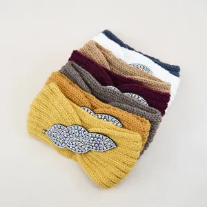 Knit rhinestone headband detailed view, stylish yoga hair band with sparkling crystal leaf design.