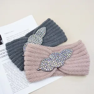 Knitted rhinestone headband detail showing textured knit fabric and sparkling crystal decor.
