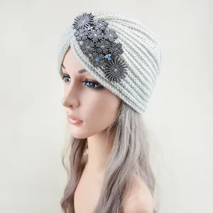 Detail view of crystal rhinestone floral knitted turban hat, warm winter headwear accessory.