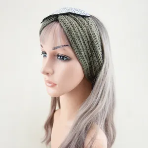 Green knitted headband with rhinestone leaf embellishment, stylish winter hair accessory for women.