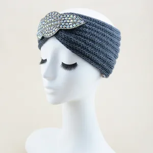 Detail view of dark grey knitted rhinestone headband, elegant winter hair accessory.