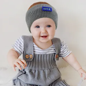 Gray knit baby headband with stylish NICE letter patch, soft wool warm hair accessory for infants.