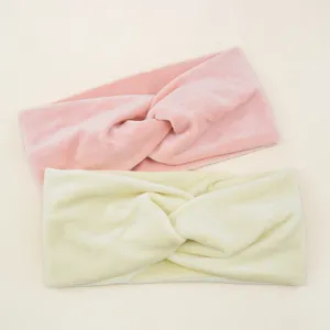 Close-up detail of plush twisted headband, soft velvet fabric texture for daily wear.