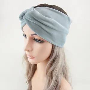 Detail shot of grey plush knotted headband showing soft velvet texture and wide design.