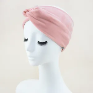 Close-up detail of the soft pink velvet knotted headband, comfortable wide hair accessory.