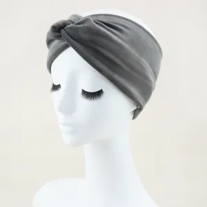 Close-up detail of the grey velvet knotted headband, showing soft plush texture and wide band.