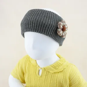 Grey knitted headband with plaid flower detail, warm ear warmer hair accessory for women.
