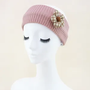 Close-up detail of the pink knitted headband featuring a cute plaid fabric flower side decor.