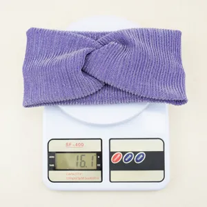 Close-up detail of the sparkly purple vertical stripe twisted headband, soft texture fabric.