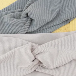 Detailed view of ribbed twisted headband, elastic yoga hair band, comfortable daily wear.