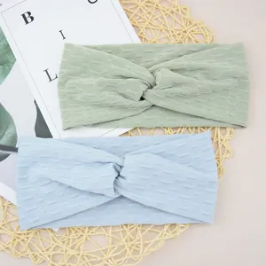Close up view of the textured twist yoga headband details, soft elastic fabric and fine workmanship.