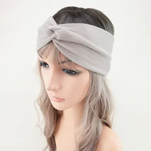 Detailed view of the light grey ribbed knotted headband, featuring soft stretch knit fabric.