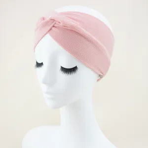 Pink ribbed knotted headband, soft elastic hair band for yoga, sports, and daily facial washing detail view.