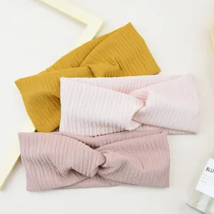 Detailed close-up of vertical striped twist headbands in yellow and pink colors for daily wear.