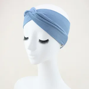Detailed view of a stylish blue ribbed twisted headband, ideal for yoga and daily sports wear.