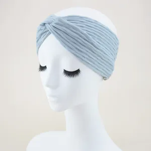 Detailed close-up view of the light blue textured wide cross headband fabric and style.