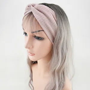 Detailed view of the stylish pink twisted headband, featuring a comfortable wide-brim design.