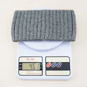 Grey knitted wide hair band detail showing weight on scale, vertical rib texture, simple style.