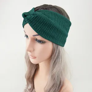 Dark green ribbed knotted headband detail view, soft elastic knit fabric for yoga and daily sports.