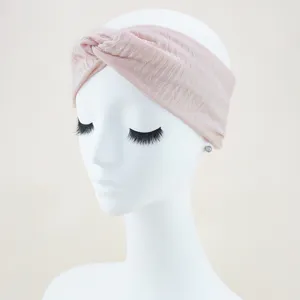 Pink ribbed knotted headband detail view, soft elastic hair accessory for daily wear.