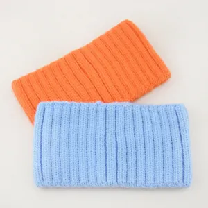 Detailed close-up of soft knitted ribbed headband, comfortable wide hair accessory.