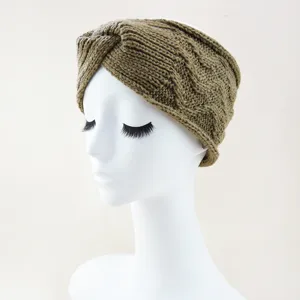 Detailed view of the khaki green knit twist headband showing cable texture and cozy warm fit.