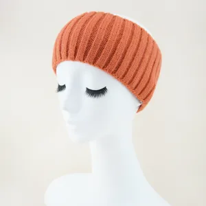 Orange knitted headband detail display, wide ribbed texture hair accessory for women.