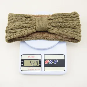 Knit fleece-lined headband detail showing product weight on scale, cozy winter ear warmer.