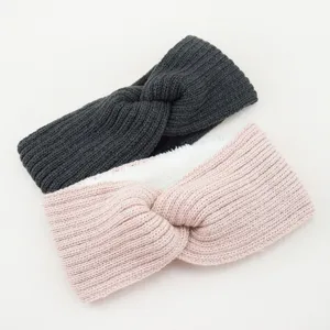 Close-up detail of soft fleece-lined knitted twist headband, warm winter ear warmer accessory.