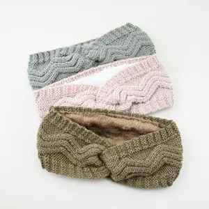 Close up of thick knitted winter fleece lined headbands in grey pink and green detail view.