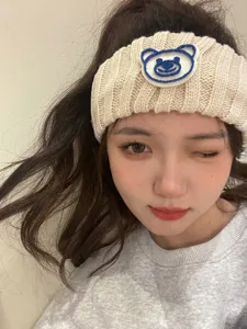 Detail shot of Korean style knitted bear head hairband, cute wide fleece headband for daily wear