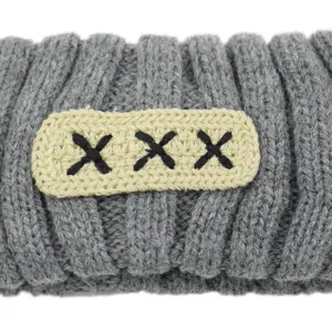 Grey knitted hair band with beige patch, wide brim winter hair accessory for women.
