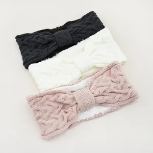 Knitted fleece cable bow headband detail showing cozy warm winter ear warmer design.