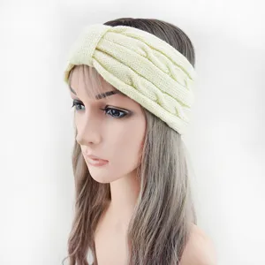 Close-up detail of the light yellow knitted cable headband, showing the soft wool texture.