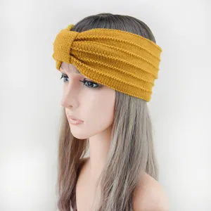 Mustard yellow knitted headband for women, cozy winter hair accessory with cute twist knot.