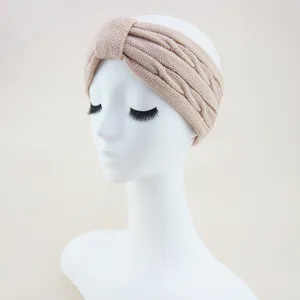 Knitted headband detail showing the cable knit texture and twist knot design for winter style.