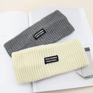Knit headband detail view, soft grey and beige wide hair bands with stylish labels for daily.