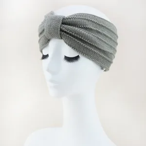 Gray knitted knotted headband closeup, soft woolen hair accessory for daily wear and sports.
