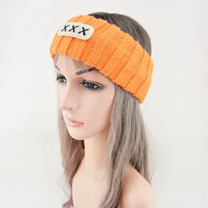 Orange knitted headband with embroidered patch, wide hair hoop for daily face washing style.