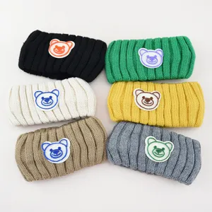 Detailed shot of cute bear embroidered knit headbands in six vibrant colors, soft texture.