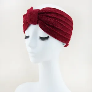 Close-up detail of wine red knitted headband, soft texture and comfortable fit.