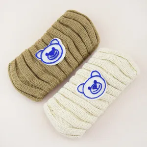 Knitted bear headband detail view, soft cozy winter hair band, cute face washing accessory.